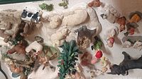 Image showing a variety of animal figurines including sheep, cows, roosters, dogs, and other animals.