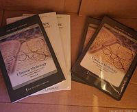 Four DVDs and two guidebooks of the Great Courses Classical Mythology set displayed on a surface.