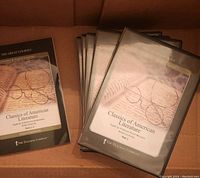 Box containing 7 parts of The Great Courses Classics of American Literature CD sets. Each part has cover art with reading glasses on an open book and includes a course guidebook.