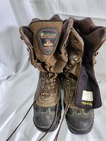 Pair of brown Lacrosse Buckmasters men's hiking boots size 8.5 viewed from front showing laces, padded tongues with branding and leather uppers.