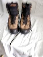 Front view of New Balance men's boots with lace-up design, tan and dark brown color combination.