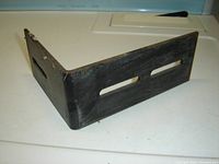 Single heavy duty black metal L-bracket with two elongated slots on each side, showing minor surface wear.