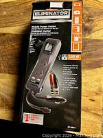 Box of Eliminator 150W mobile power outlet inverter showing product details and features.