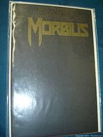 Photo of Morbius comic book issue #12 featuring the Midnight Massacre storyline; dark cover with gold lettering, sealed in a protective sleeve.