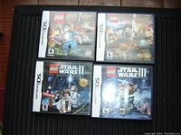 Top-down photo showing four Nintendo DS game cases: Lego Harry Potter Years 5-7, Lego Lord of the Rings, Lego Star Wars II The Original Trilogy, Lego Star Wars III The Clone Wars.