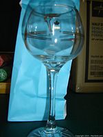Single Petro Canada wine glass with Olympic design and gold trim, front view showing the shape and decoration
