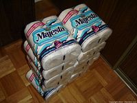Stack of 40 rolls of Majesta brand toilet paper with visible packaging showing brand and 2-ply designation