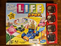 Box of The Game of Life Junior game, showing colorful, kid-friendly design and icons