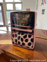 Two pairs of Kate Spade socks in original packaging with leopard and cheetah prints.