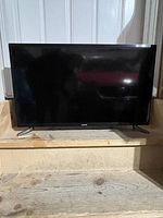 Samsung flat screen TV with 28 inch screen size, placed on wooden steps