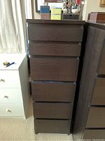 Front view of the dresser showing six drawers with cut-out handles, dark brown wood finish.