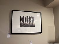 Black and white framed photo print of tall trees, matted in white, set in black frame