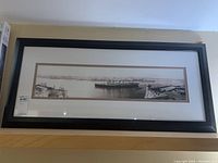 Frontal view of framed panoramic black and white harbor print, showing overall condition and size