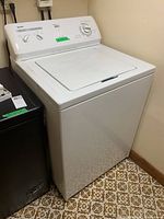 Full view of white Kenmore top load washing machine showing overall condition and size.
