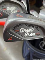 Close-up of Powerbilt Grand Slam oversize performance golf irons with 3 and 4 clubs visible.
