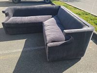 Front view of L-shaped sectional showing both left and right arms and seat cushions