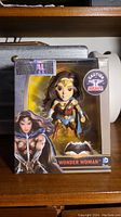 Front view of unopened Wonder Woman Metals Die Cast figure in original packaging showing character artwork and figure inside clear plastic window.