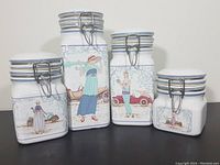 Front view of all four vintage ceramic canisters showing Art Deco lady illustrations and steel wire hinged lids, in graduated sizes.