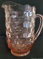Full view of pink Depression glass pitcher with geometric Cubist block pattern, showing raised texture, handle, and spout