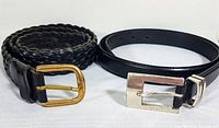 Photo showing both belts side by side, highlighting the braided texture and gold-tone buckle on the Italian leather belt, and the smooth leather and silver-tone buckle of the Fossil belt.