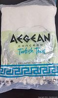 Aegean Turkish beach towel packaged in clear plastic, showing branding and pattern.