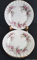 Two side plates showing floral Lavender Rose pattern with pink roses, purple accents, and gold trim on scalloped edges.