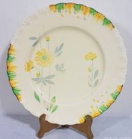 Full view of Grindley Milady Art Deco dinner plate with floral design and brush stroke colors on scalloped rim.