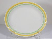 Full view of the oval platter showing the scalloped edge and color details.