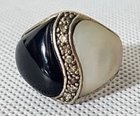 Front view of the vintage .925 sterling silver ring showing black and white inlaid sections separated by beaded silver detail.