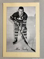 Black and white photo of Allan Stanley in Toronto Maple Leafs uniform adhered to cream cardboard backing.