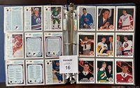 Photo showing multiple hockey cards displayed in binder pages, front and back of cards visible, including several player cards in rows of three per page.