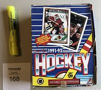 Front of the sealed 1991-92 OPC hockey card box, showing the brand, season and images of players
