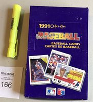 Photo of front of 1991 OPC Premier Baseball Wax Box with three baseball card images and blue background, yellow and red text.