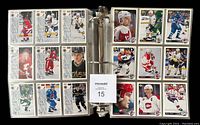 Full view of multiple hockey cards arranged in Ultra Pro Platinum binder pages showing front of cards with player photos and details, grouped by series.