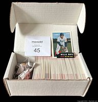 White storage box containing a nearly full set of 1992 Topps Archives baseball cards, neatly stacked with one card of Willie Mays propped up in front.
