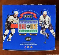 Closed blue wax box with NHL players displayed, marked with a $2.50 price tag, containing 36 booster packs of 12 cards each.