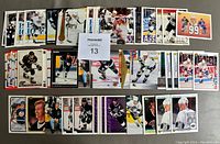 Photo showing a spread of various Wayne Gretzky hockey cards arrayed in rows, depicting different card designs, team jerseys, and styles.
