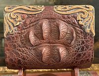 Front exterior view showing reptile skin scutes and gold corner embellishments