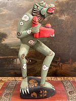 Front view of the Oaxacan wood carving displaying detailed paint and posture