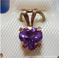 Close-up front view of heart-shaped purple amethyst pendant set in 10K yellow gold, showing 4 claw prong setting and bail.