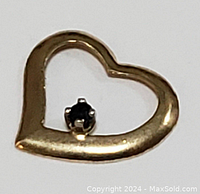 Close-up front view of the 10K yellow gold floating heart pendant showing the heart shape and black onyx gemstone.