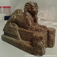 Side view showing the sphinx's body and detailed headdress with white inlay lines