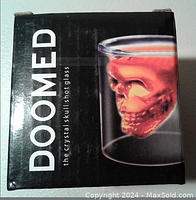 Box front with 'DOOMED' text and image of the skull shot glass filled with red liquid