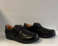 Side angle photo showing the full pair of black ladies comfort shoes with adjustable straps.