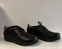 Side angle showing profile of black ladies comfort shoes, lace-up style, new condition.