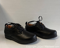 Side angled view of black ladies comfort shoes showing shape, quality and lace-up detail.