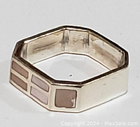 Close-up photo of hexagonal sterling silver ring with mother of pearl inlay showing geometric square pattern on side of band.