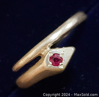 Close-up image of sterling silver ring showing the ruby stone and split band design from an angle.