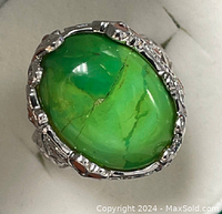 Top view of the sterling silver ring highlighting the large polished oval green agate gemstone with natural veining.