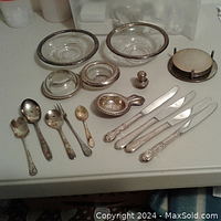 Overview of all vintage sterling silver and glassware items including cutlery, bowls, and salt shaker.